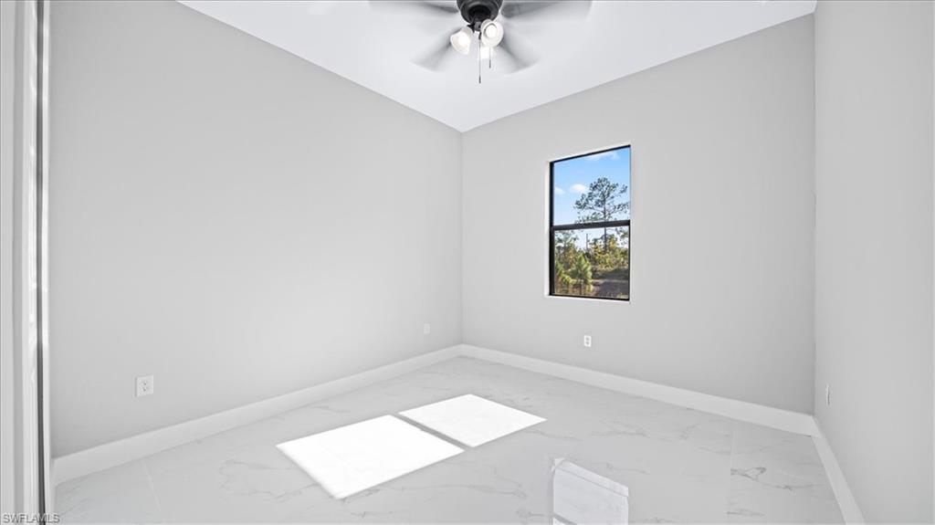 926 Winters Street East Lehigh Acres, FL 33974 - Photo 23 of 36 an empty room with a window