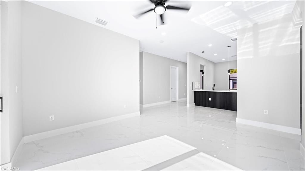 926 Winters Street East Lehigh Acres, FL 33974 - Photo 24 of 36 a view of a kitchen with a sink and cabinets