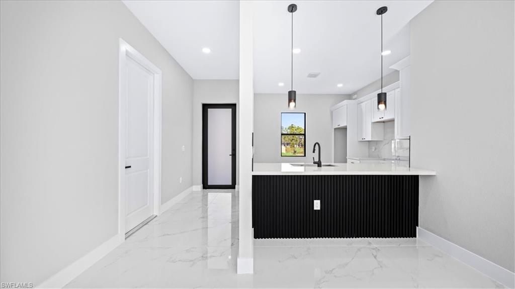 926 Winters Street East Lehigh Acres, FL 33974 - Photo 25 of 36 a view of kitchen and kitchen with a sink