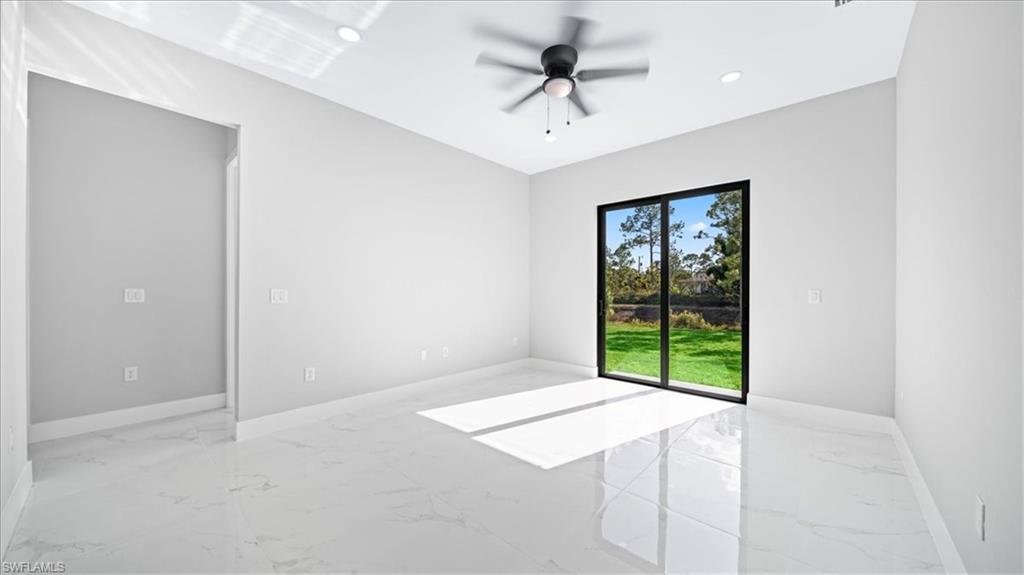 926 Winters Street East Lehigh Acres, FL 33974 - Photo 27 of 36 a view of an empty room with a window