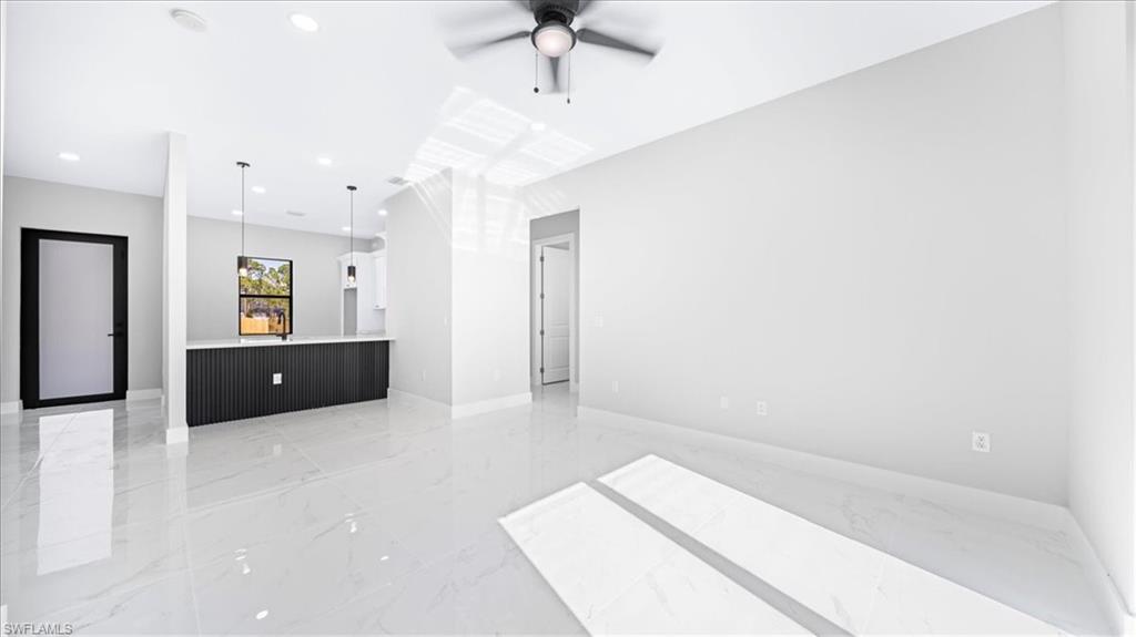 926 Winters Street East Lehigh Acres, FL 33974 - Photo 28 of 36 a living room with furniture and a ceiling fan