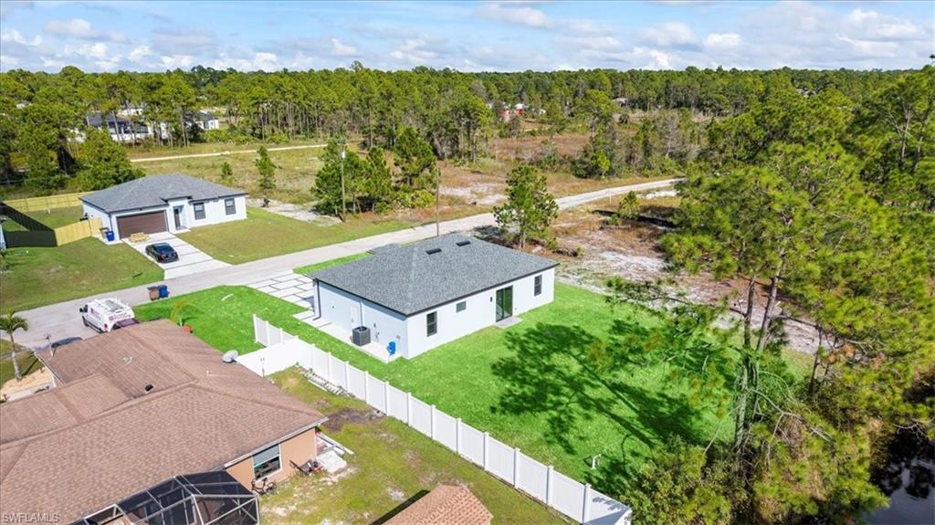 926 Winters Street East Lehigh Acres, FL 33974 - Photo 33 of 36 an aerial view of a house with a garden