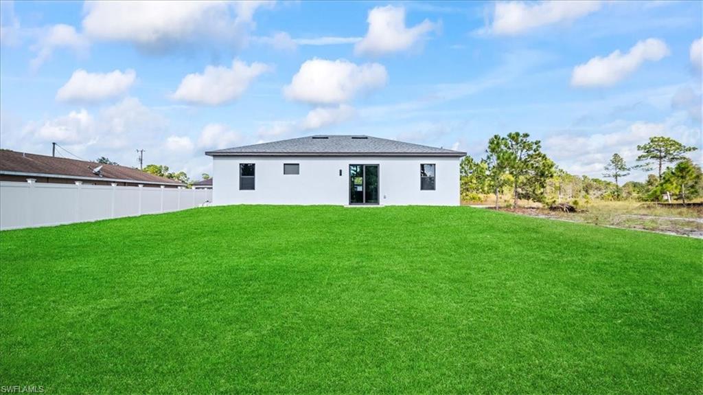 926 Winters Street East Lehigh Acres, FL 33974 - Photo 5 of 36 a view of a house with a yard and potted plants