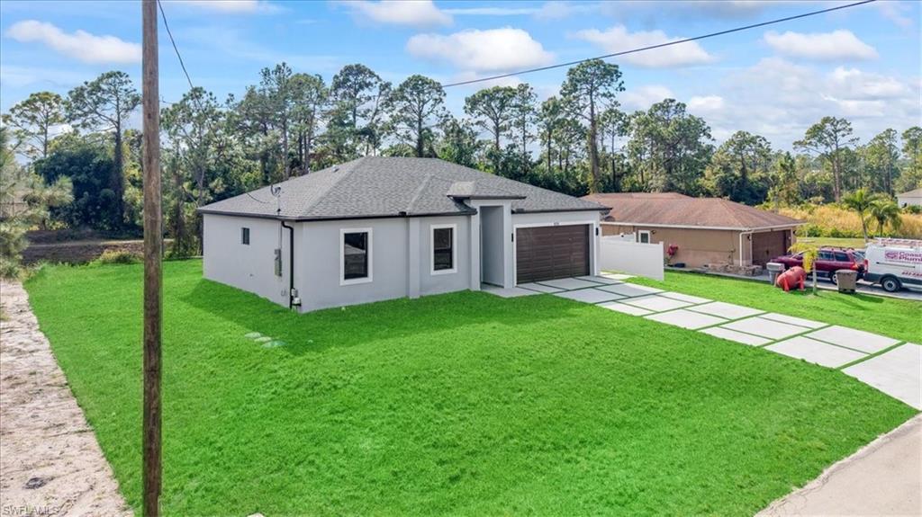 926 Winters Street East Lehigh Acres, FL 33974 - Photo 6 of 36 a aerial view of a house with garden