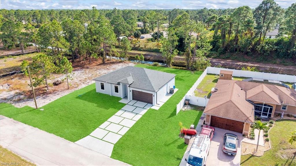 926 Winters Street East Lehigh Acres, FL 33974 - Photo 7 of 36 an aerial view of a house with a garden