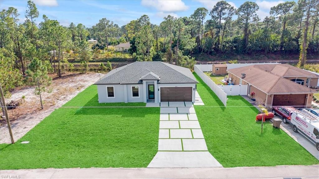 926 Winters Street East Lehigh Acres, FL 33974 - Photo 8 of 36 a aerial view of a house with a yard