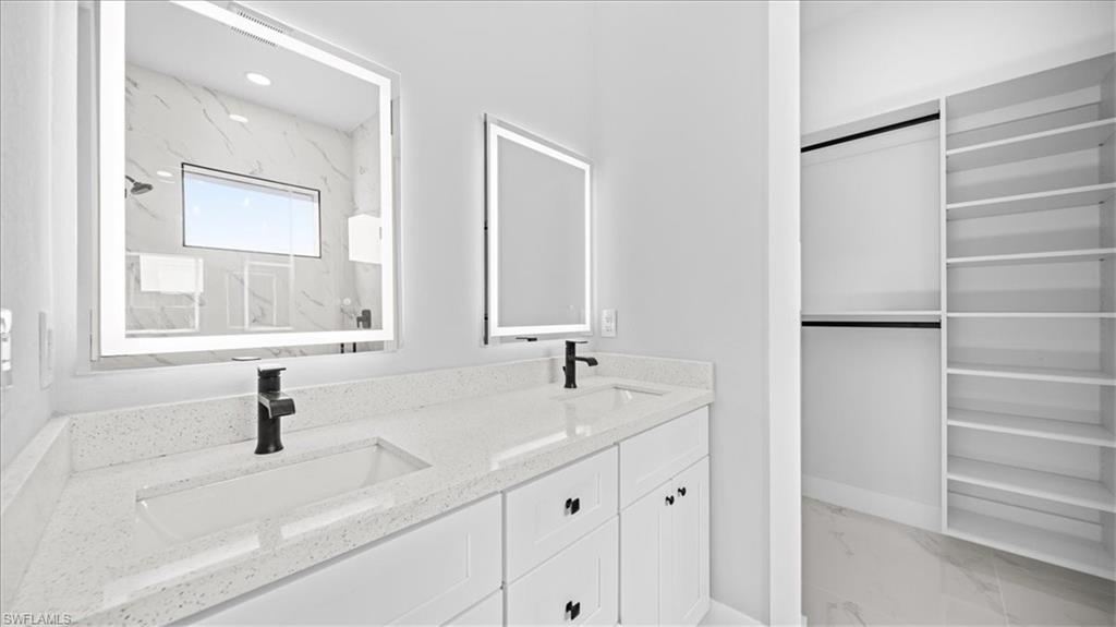 926 Winters Street East Lehigh Acres, FL 33974 - Photo 9 of 36 a bathroom with a sink and a mirror