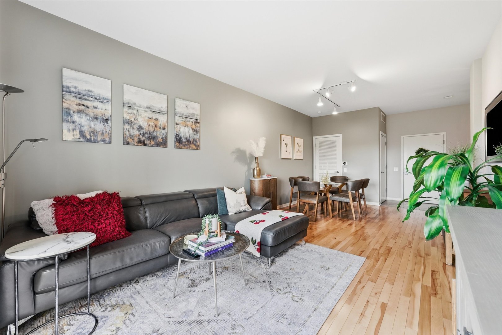 1155 West Roosevelt Road, Unit 404 Chicago, IL 60608 - Photo 13 of 30 a living room with furniture potted plant and a rug