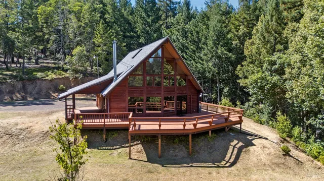 a view of house with roof deck and seating space
