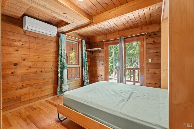a bed sitting in a bedroom next to a window
