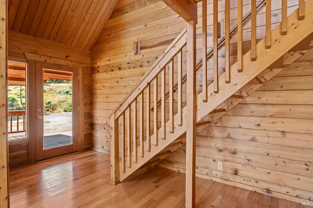 a view of entryway with wooden floor and stairs