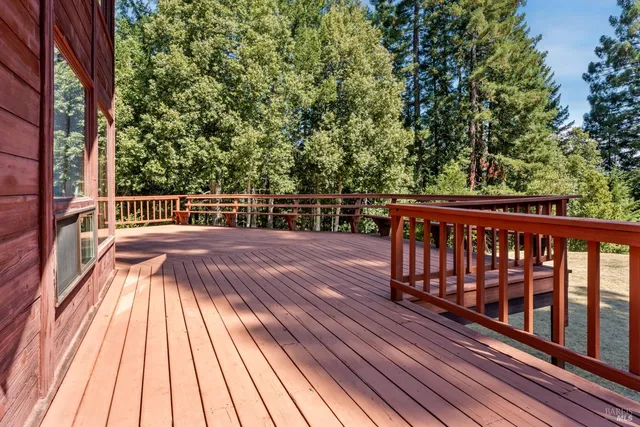 a view of backyard with a deck and wooden floor