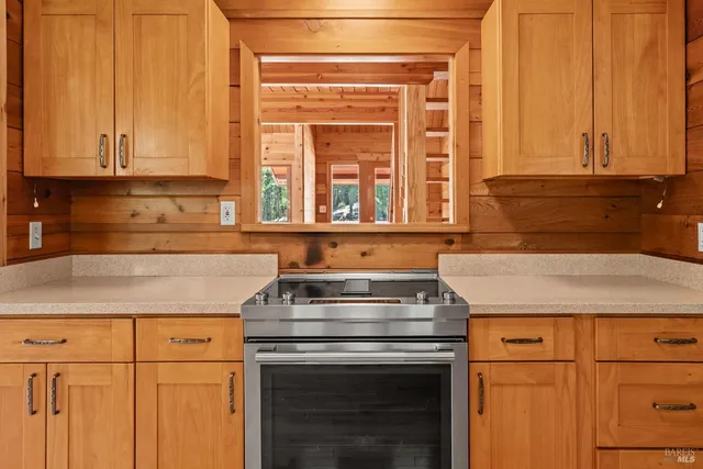 a stove top oven sitting inside of a kitchen