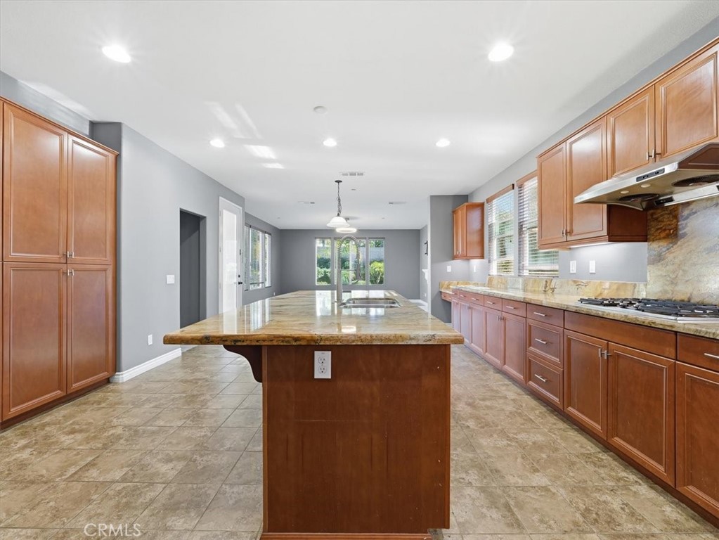 2947 Gilbert Avenue Corona, CA 92881 - Photo 18 of 60 a kitchen with granite countertop counter top space a sink stainless steel appliances and cabinets