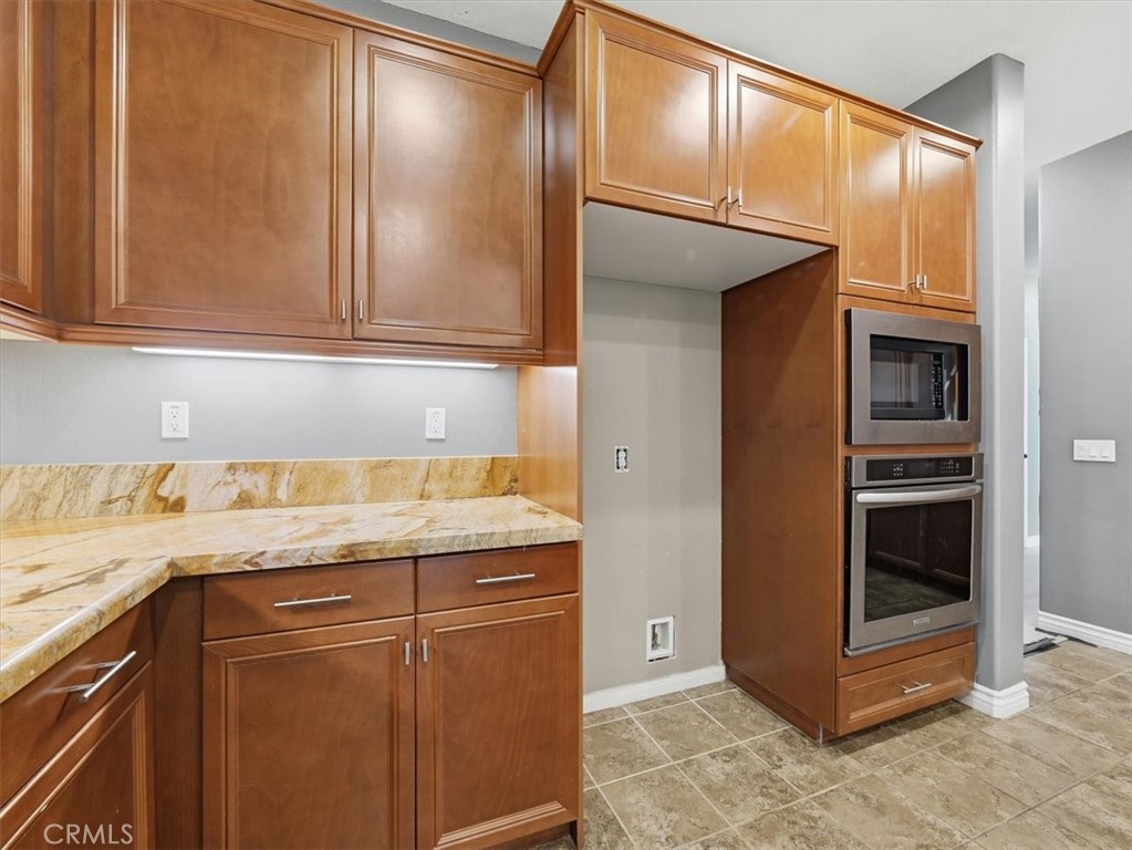 2947 Gilbert Avenue Corona, CA 92881 - Photo 19 of 60 a kitchen with granite countertop cabinets and stainless steel appliances
