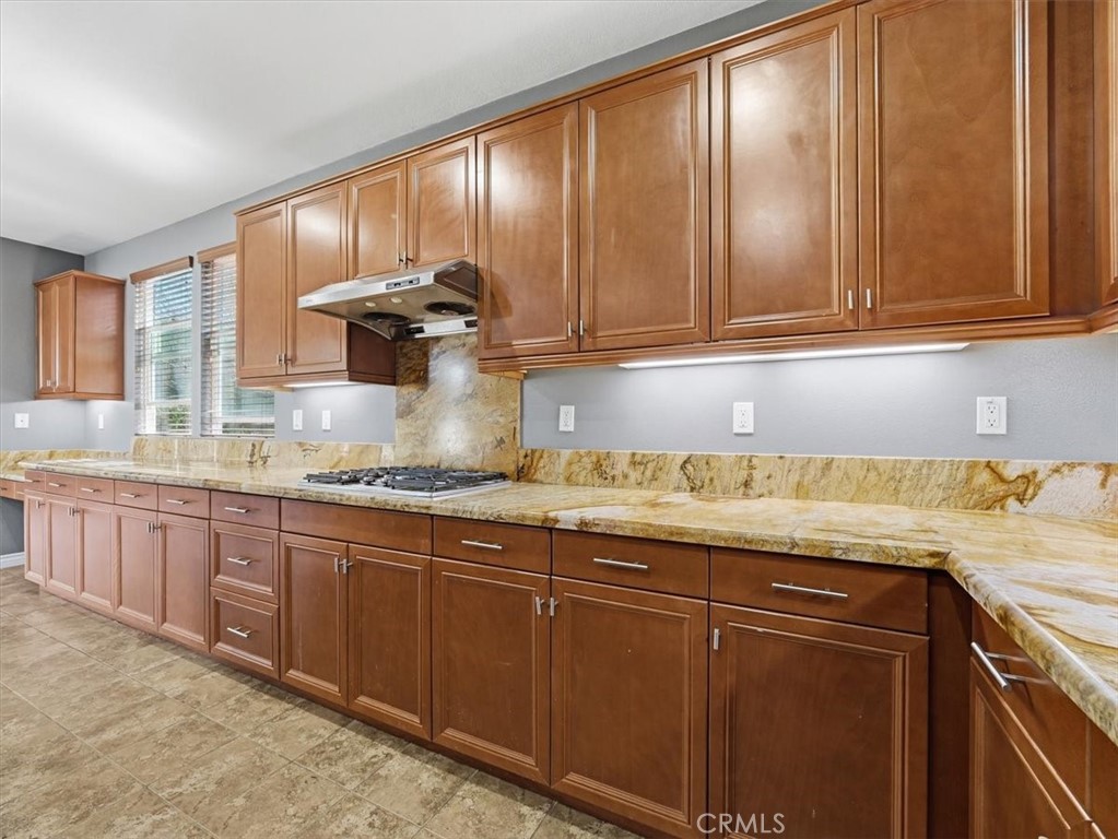 2947 Gilbert Avenue Corona, CA 92881 - Photo 20 of 60 a kitchen with granite countertop wood cabinets stainless steel appliances a sink and window