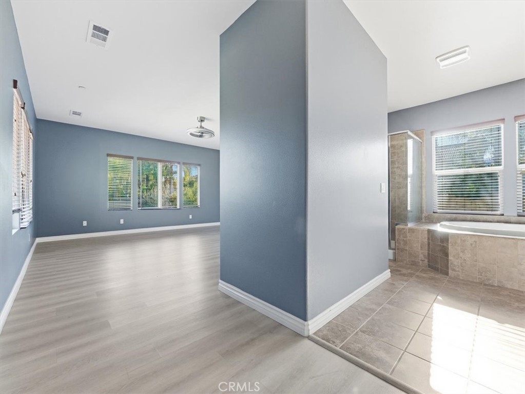 2947 Gilbert Avenue Corona, CA 92881 - Photo 25 of 60 an empty room with wooden floor and windows