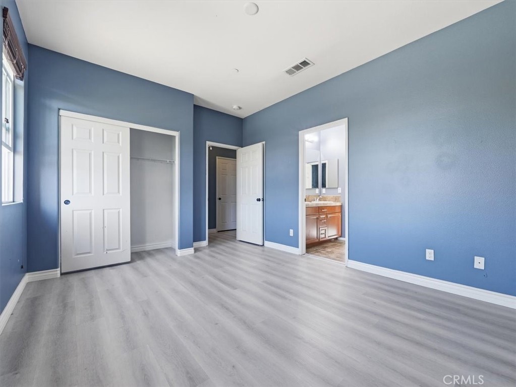 2947 Gilbert Avenue Corona, CA 92881 - Photo 28 of 60 a view of an empty room with wooden floor and a window