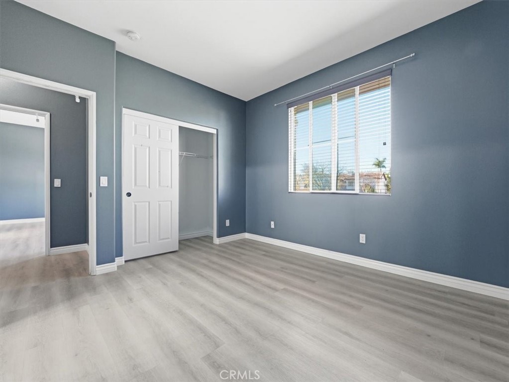 2947 Gilbert Avenue Corona, CA 92881 - Photo 41 of 60 a view of an empty room with wooden floor and a window