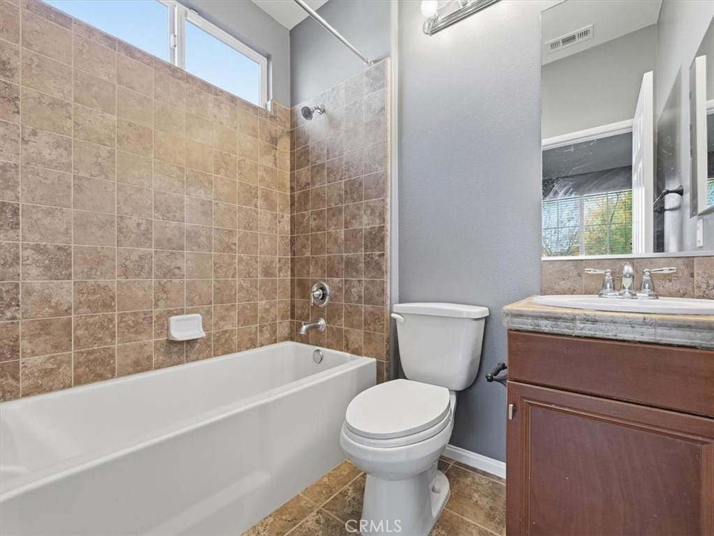 2947 Gilbert Avenue Corona, CA 92881 - Photo 51 of 60 a bathroom with a granite countertop toilet a sink and bathtub