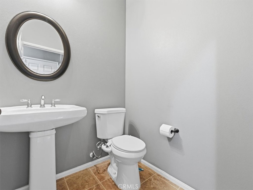 2947 Gilbert Avenue Corona, CA 92881 - Photo 52 of 60 a bathroom with a sink and a mirror