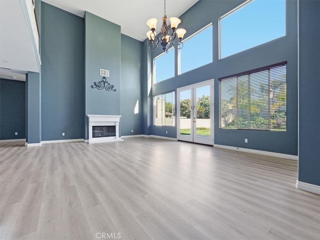 2947 Gilbert Avenue Corona, CA 92881 - Photo 6 of 60 a view of an empty room with a window and wooden floor