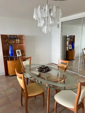 a dining room with furniture and chandelier