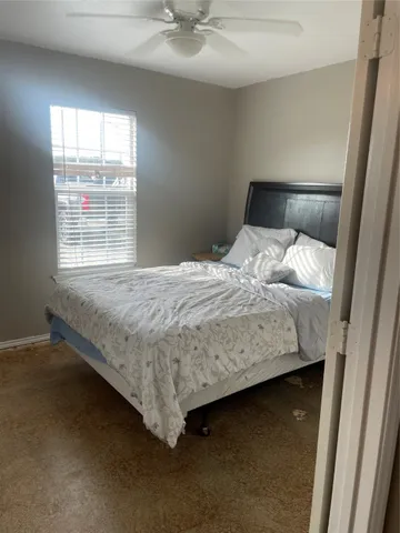 a bedroom with a bed and window