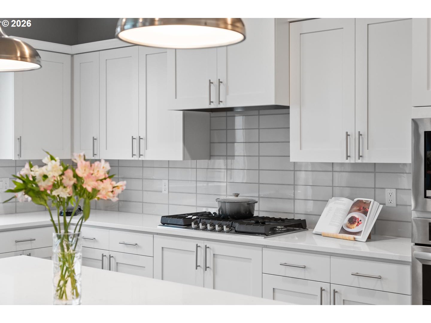 5489 North 91st Avenue Camas, WA 98607 - Photo 17 of 44 a kitchen with stainless steel appliances granite countertop a white cabinets a stove a chimney