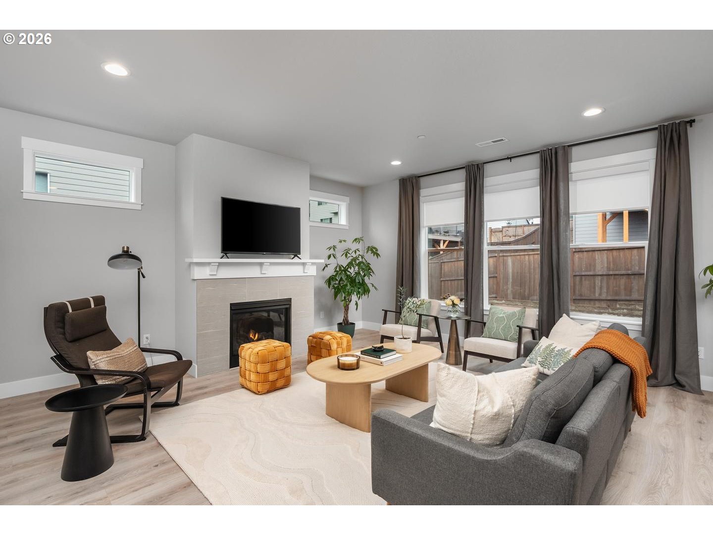 5489 North 91st Avenue Camas, WA 98607 - Photo 5 of 44 a living room with furniture a fireplace and a floor to ceiling window