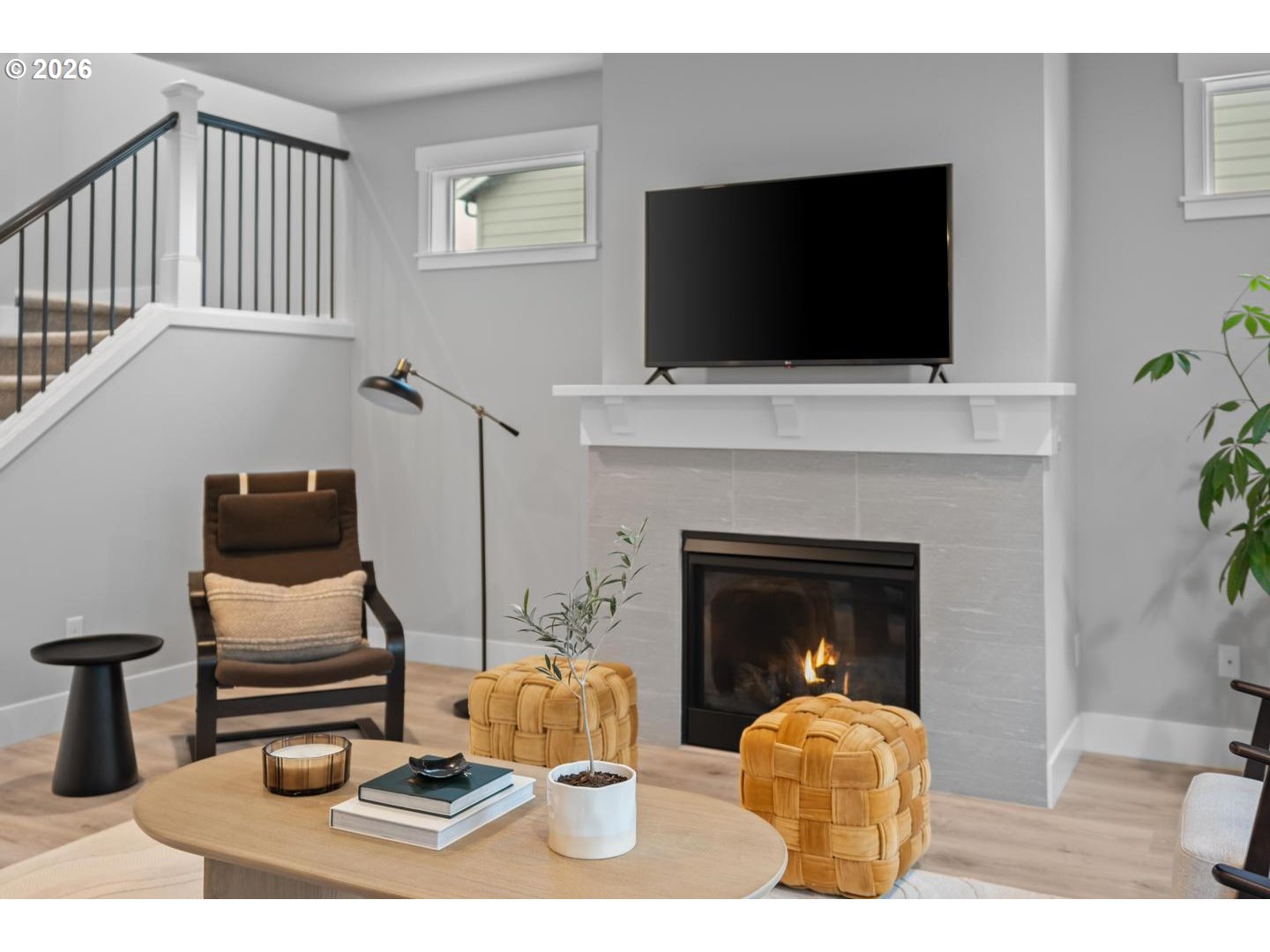 5489 North 91st Avenue Camas, WA 98607 - Photo 6 of 44 a living room with furniture a flat screen tv and a fireplace