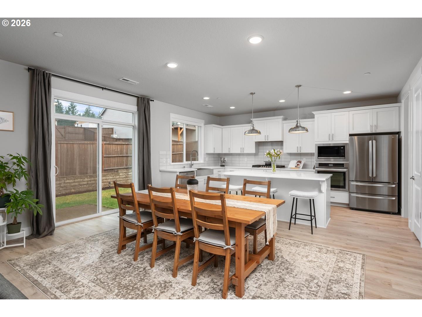 5489 North 91st Avenue Camas, WA 98607 - Photo 9 of 44 a open dining room with stainless steel appliances kitchen island granite countertop a dining table chairs and granite counter top