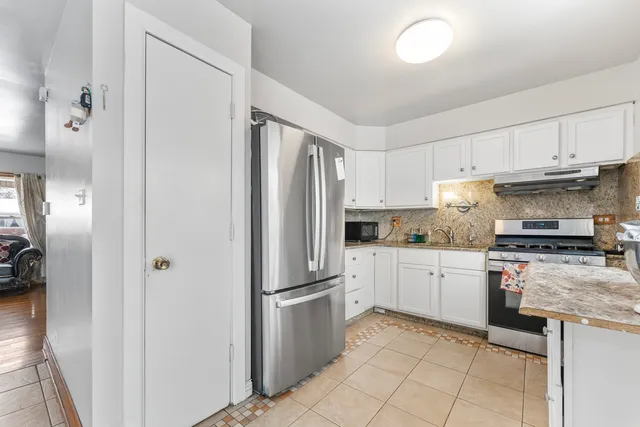 a kitchen with cabinets stainless steel appliances and a counter top space