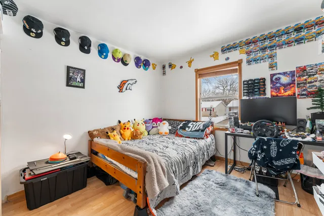 a bedroom with a bed and a desk