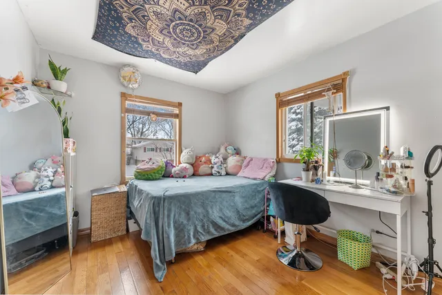 a bedroom with a bed and a workspace