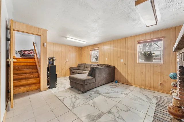 a living room with furniture and a painting on the wall