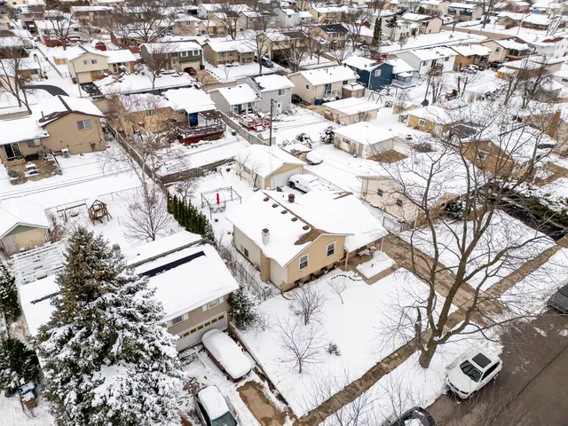an aerial view of residential houses with outdoor space