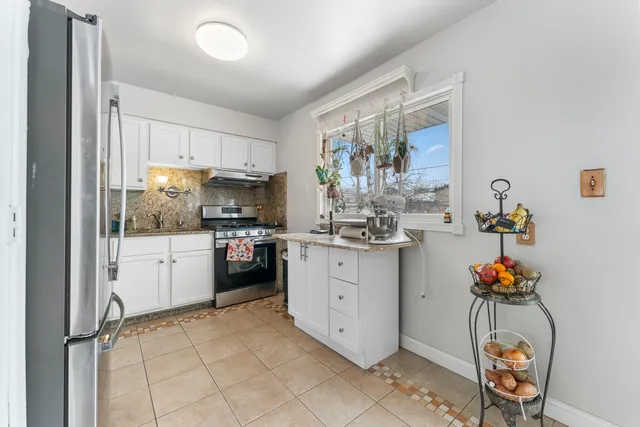 a kitchen with a refrigerator and cabinets