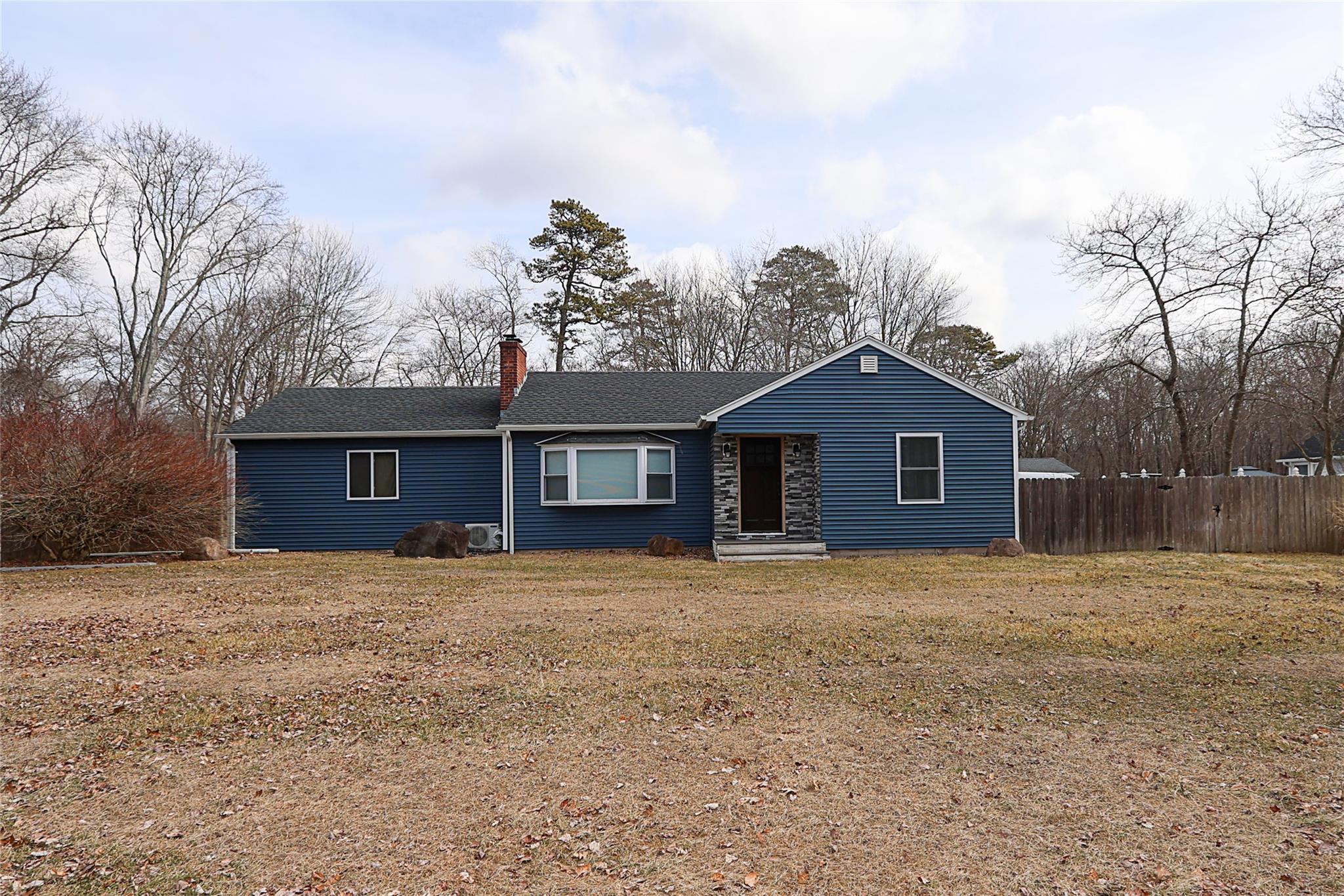 a front view of house with yard and trees