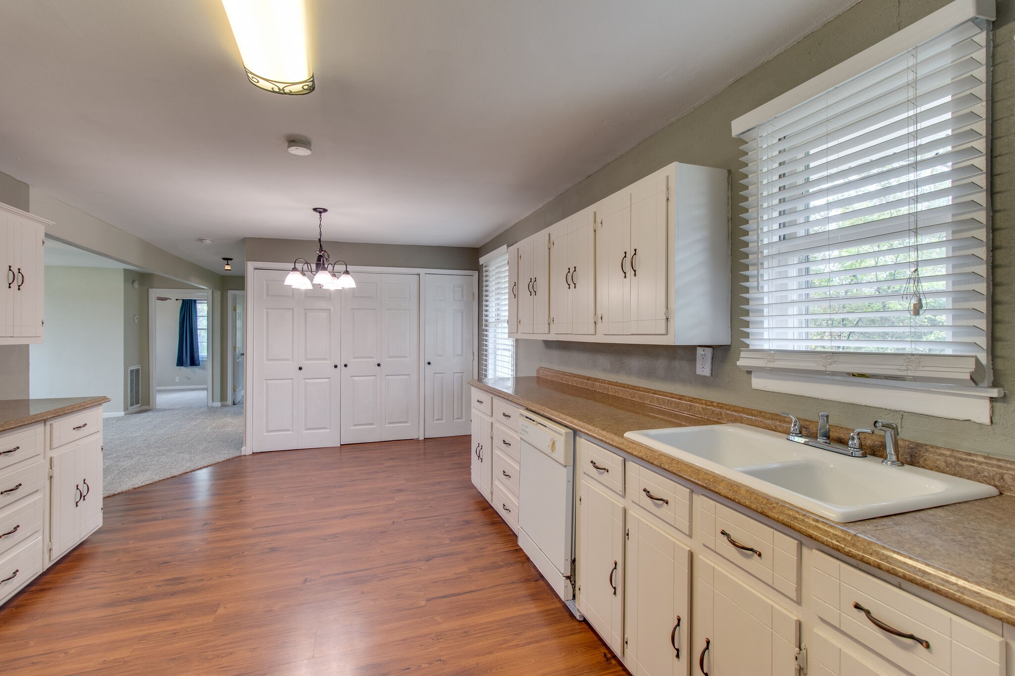 4942 Kedron Road Columbia, TN 38401 - Photo 9 of 17 a large kitchen with granite countertop a sink and dishwasher cabinets with wooden floor