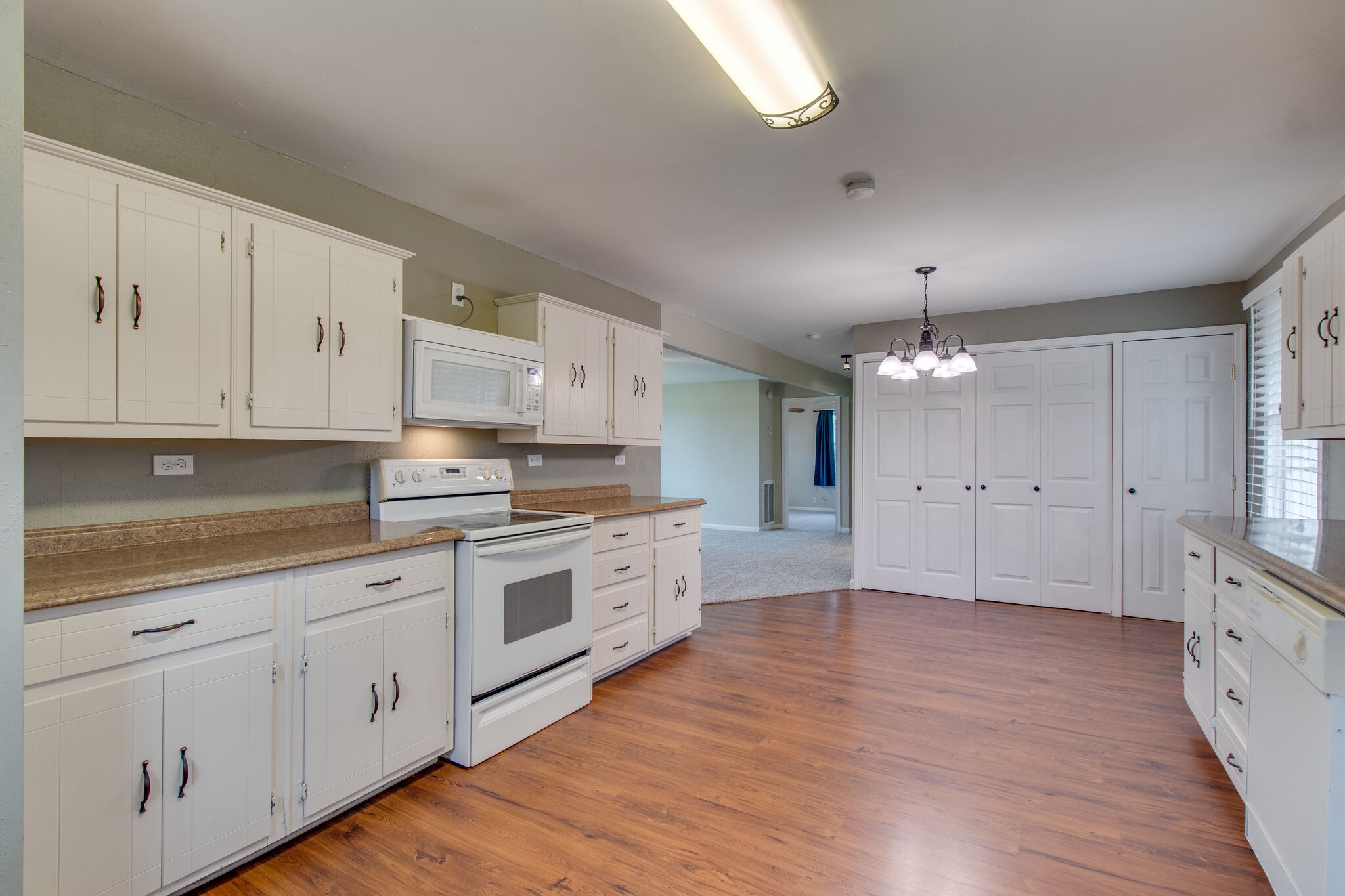4942 Kedron Road Columbia, TN 38401 - Photo 10 of 17 a large kitchen with granite countertop a white stove top oven and white cabinets