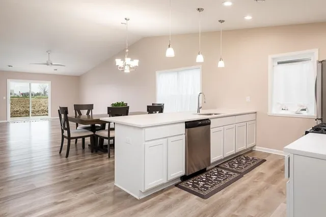 a kitchen with stainless steel appliances a sink stove and microwave