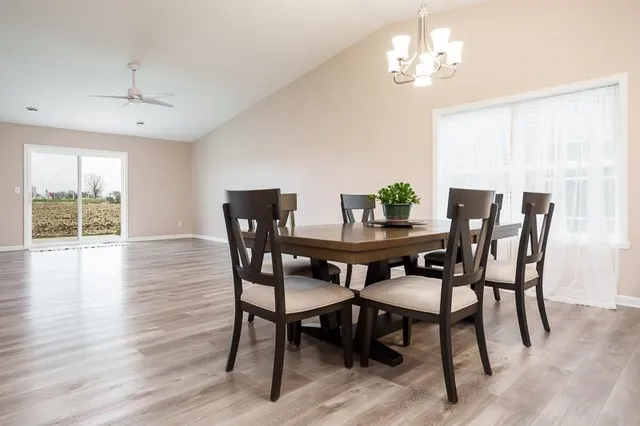 a view of a dining room with furniture wooden floor and chandelier
