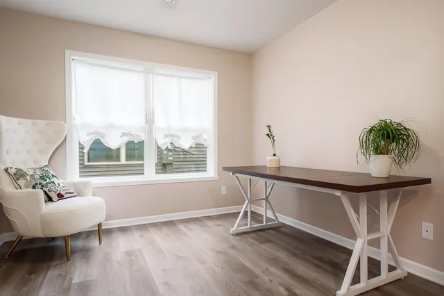 a view of a room with wooden floor and a window