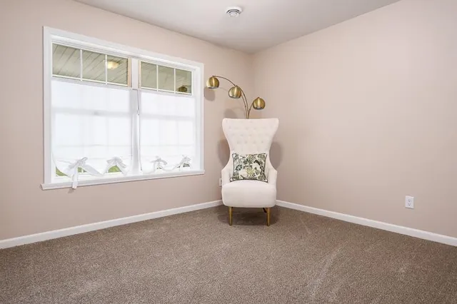 an empty room with windows and air conditioner