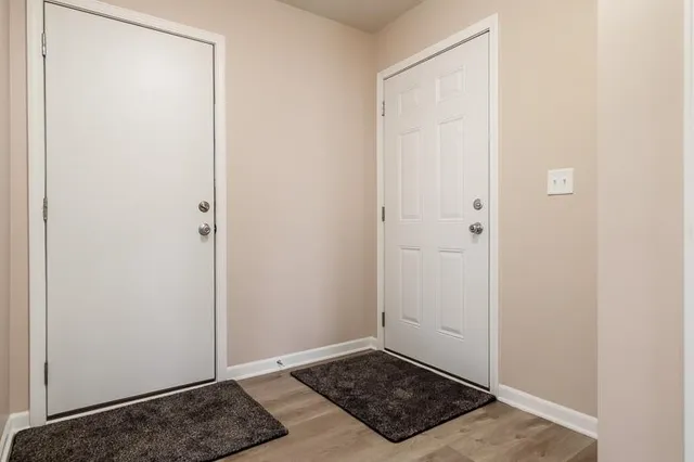 a kitchen that has a lot of cabinets in it with a dining table and chairs