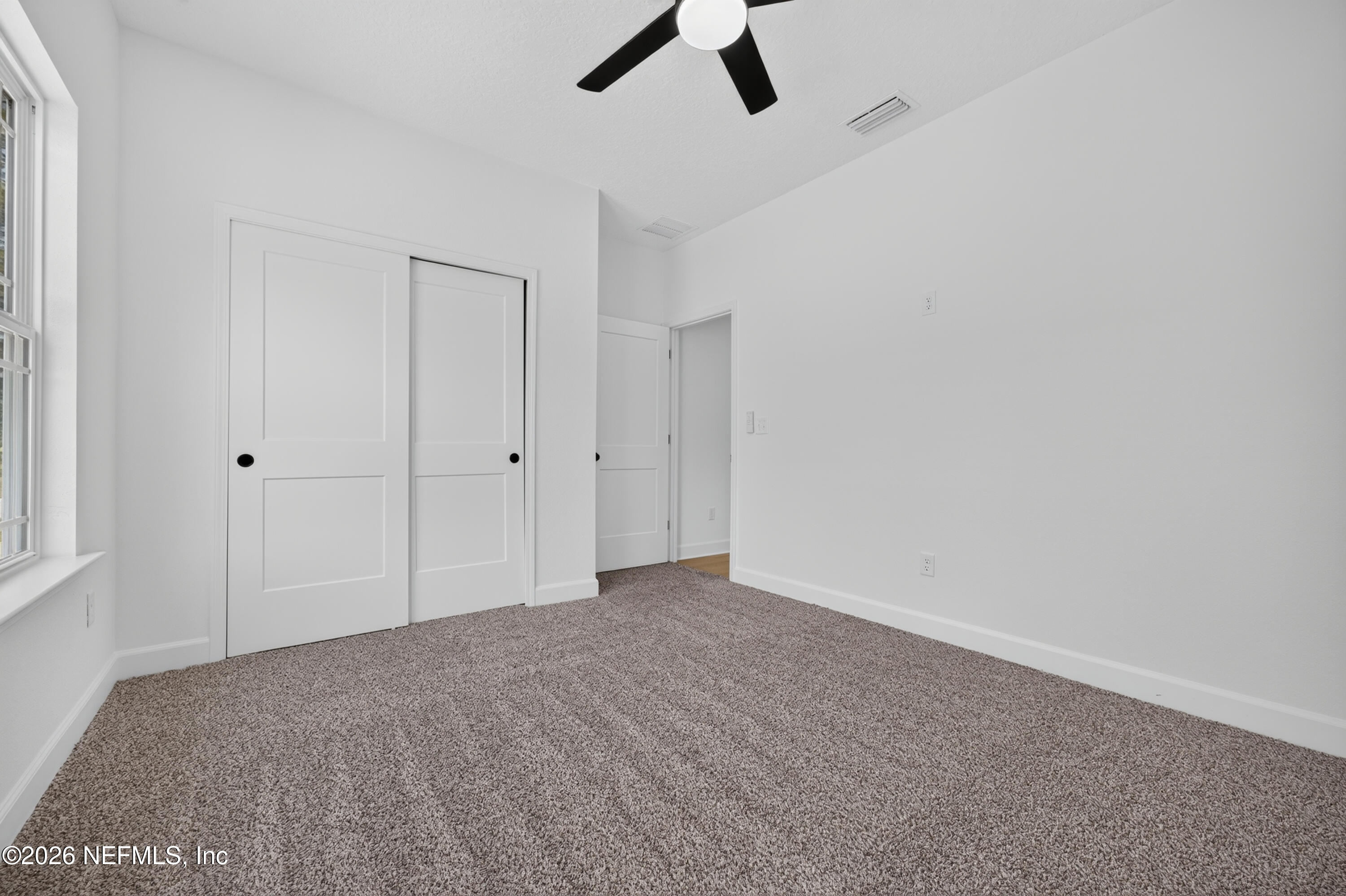 4362 Angora Street Middleburg, FL 32068 - Photo 17 of 31 an empty room with ceiling fan and window