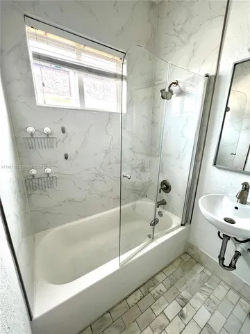 a bathroom with a bathtub and toilet