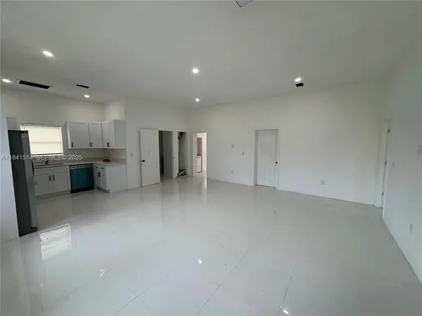a view of a kitchen with a sink and a refrigerator