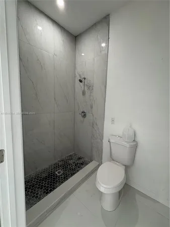 a bathroom with a toilet and shower
